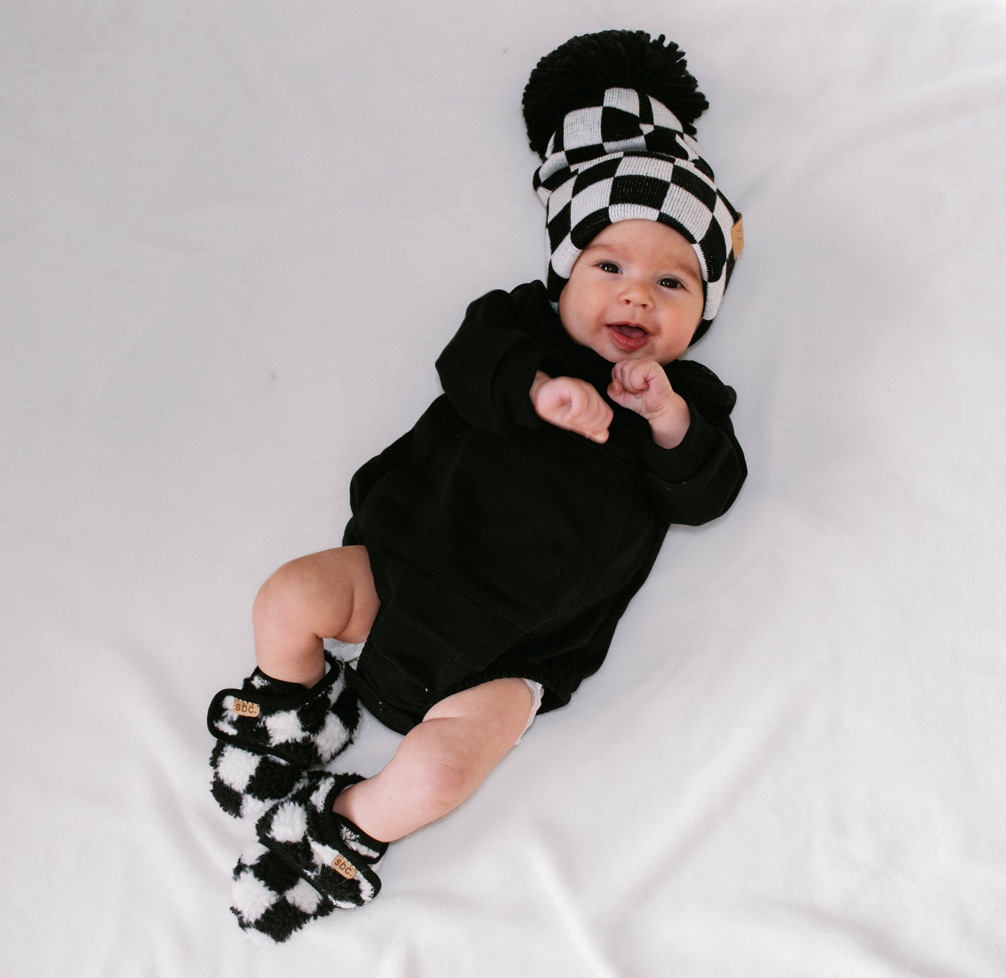 the newborn sherpa bootie — black + white checkered