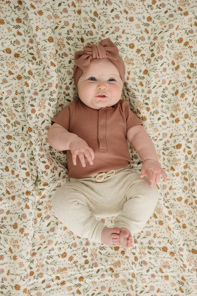 dusty rose organic cotton ribbed snap bodysuit