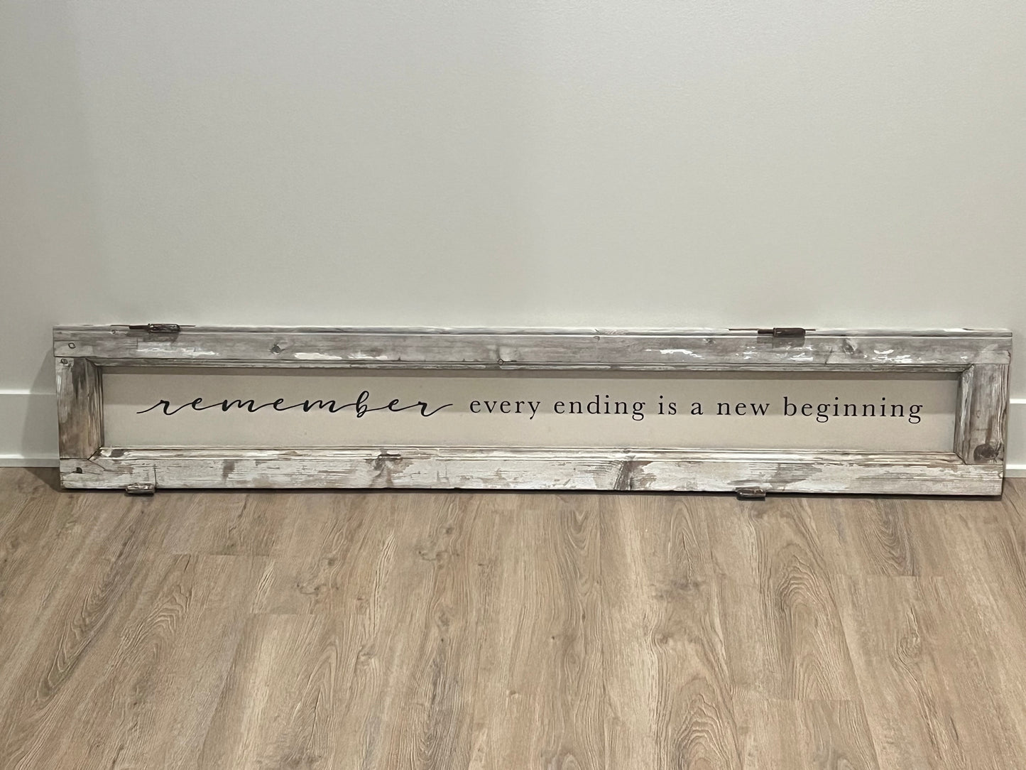 handcrafted "remember every ending is a new beginning" sign