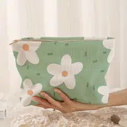 green floral corduroy makeup bag with a zipper